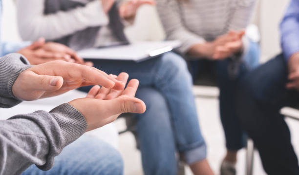 istock Closeup of unrecognizable male hands applauding at group therapy session 1202680759