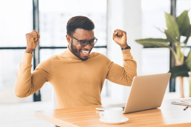 istock Overjoyed black business man celebrating his win 1202681121