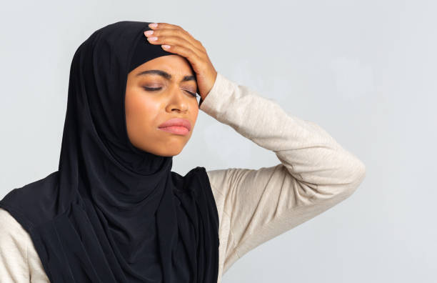 istock Black Islamic Woman In Hijab Touching Her Forehead, Suffering From Headache 1202681729