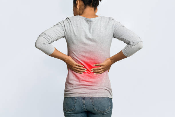 istock Black woman placing her hands on lower back 1202682077