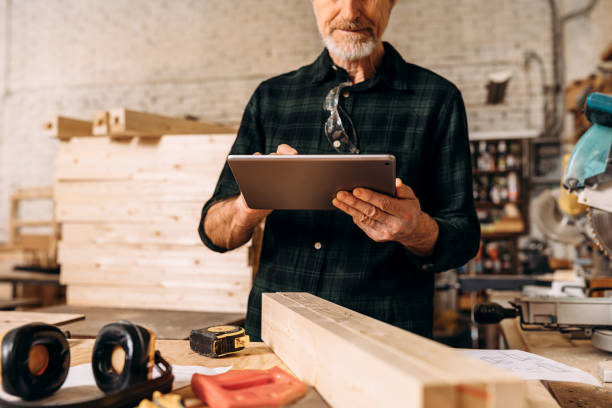 istock Cropped shot of a senior carpenter looking at digital tablet in his workshop 1202682143