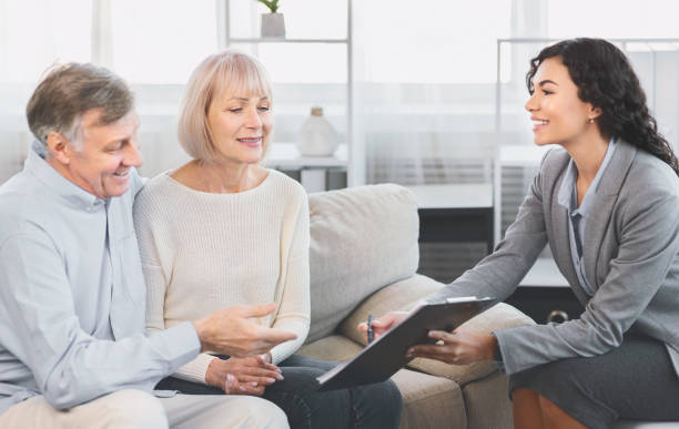 istock Senior couple consulting with adviser at office 1202682229