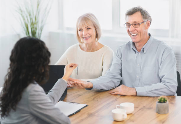 istock Happy elderly couple getting new house key 1202682309