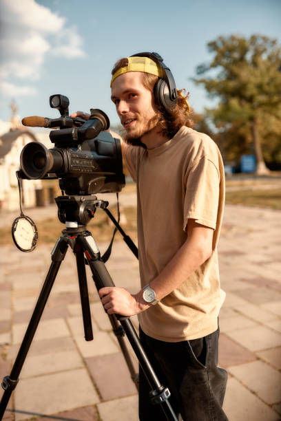 istock Always there. Video camera operator at work. Journalism industry, live streaming concept. 1202683214