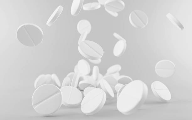 istock Many falling white pharma medication pills isolated on grey background 3d illustration render 1202683238