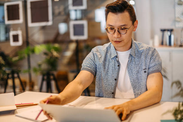istock Asian male designer working in the office 1202683782
