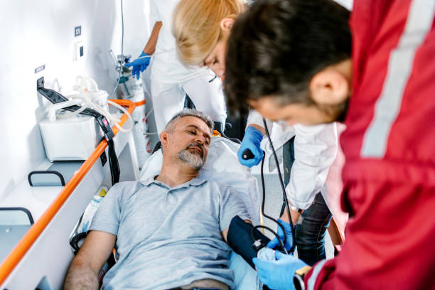 istock Doctor and paramedics helping mature man 1202684852