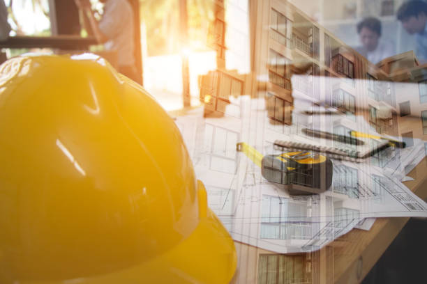 istock Architect desk ,Business,engineering concept,construction site, soft focus, vintage tone, working with blueprints in the office.Home Project to Offer Management 1202685837