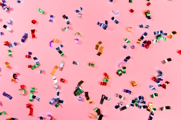 istock Colour sparkles on pink holiday background. Festive backdrop for your projects. 1202686596