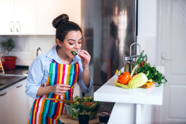 istock Young woman trying a salad 1202686694