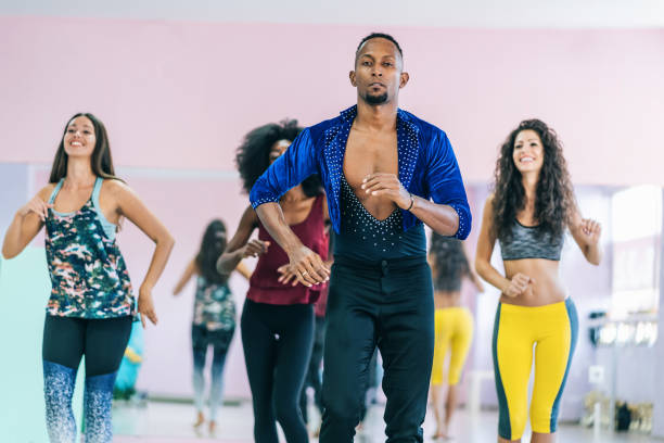 istock Brazilian male teacher and students practicing in studio 1202686888
