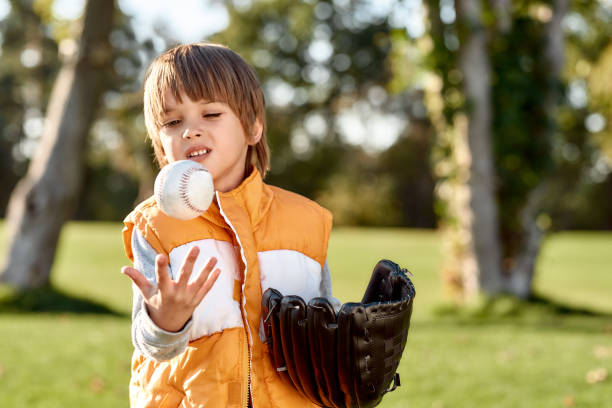 istock Childhood education. Little boy is ready to play baseball 1202689931