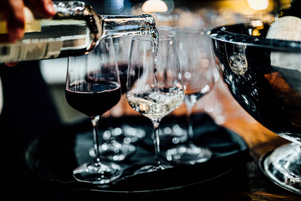 istock Man is pouring red or white wine 1202689966