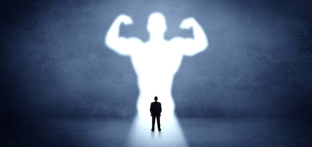 istock Businessman standing in front of a strong hero vision 1202691751
