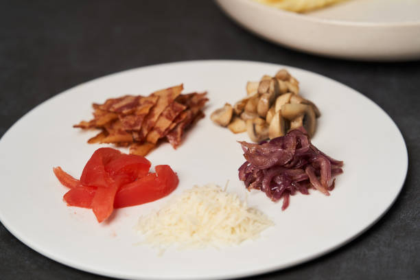 Traditional breakfast omelette with bacon, tomatoes, mushrooms, onion