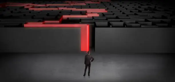 Photo of Businessman starting a stated dark labyrinth