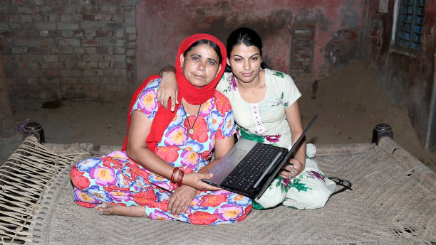 istock Mother & daughter using laptop at home 1202692168