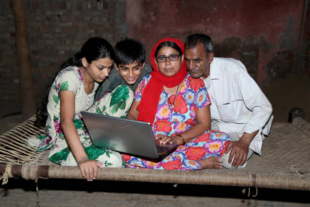 istock Indian family using laptop at home 1202692187