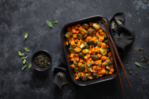 istock Brussels sprouts baked with butternut squash, top view 1202693092