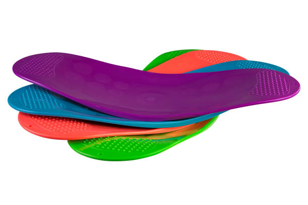 istock several multi-colored balancing boards for fitness or for Pilates, on a white background, boards are stacked 1202693301