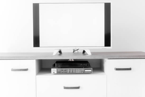istock TV with white screen on a stand in the room. 1202693433