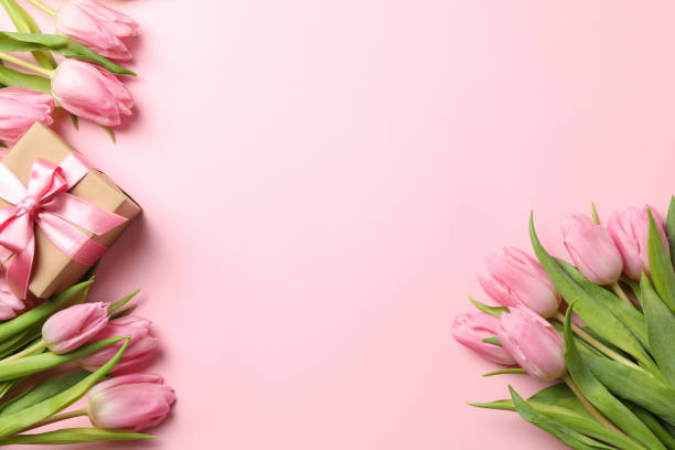 istock Beautiful tulips and gift box on pink background, top view 1202694589
