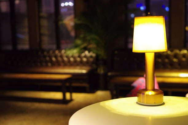 istock Table lamp on white round bar table in vintage lounge 1202694709