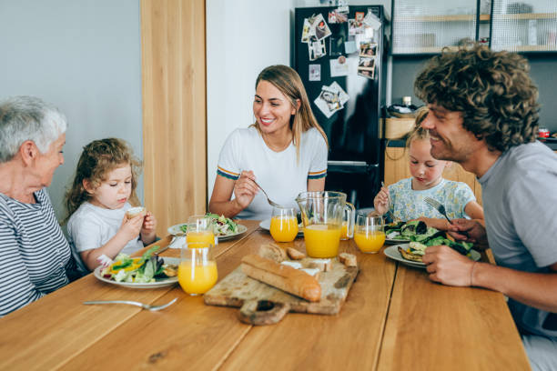 istock Multi-generation family having lunch at home. 1202694761