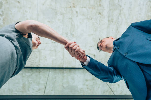 istock Businesspeople shaking hands 1202694762
