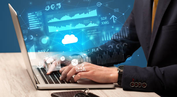 istock Hand typing on laptop graphs and charts and reports concept around 1202695222