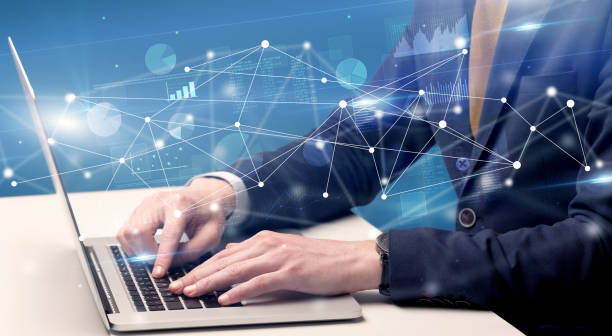 istock Hand typing on laptop with linked report and charts around 1202695320