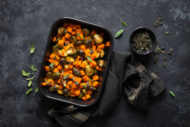 istock Brussels sprouts baked with butternut squash, top view 1202695343