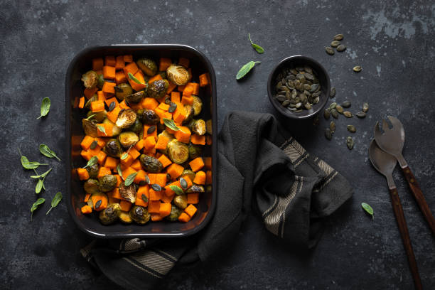 istock Brussels sprouts baked with butternut squash, top view 1202695348