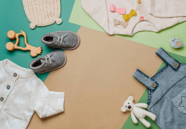 istock Baby clothes and shoes on neutral background 1202695585