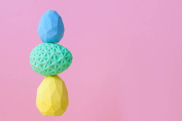istock Geometric Easter eggs standing on top of each other on pink background 1202695654