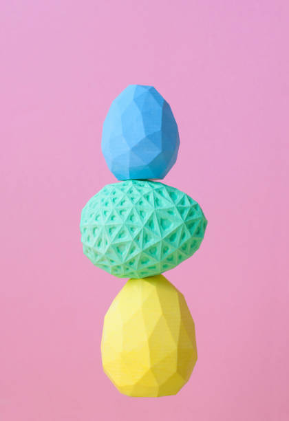 istock Geometric Easter eggs standing on top of each other on pink background 1202695661