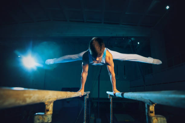 istock Little male gymnast training in gym, flexible and active 1202696504