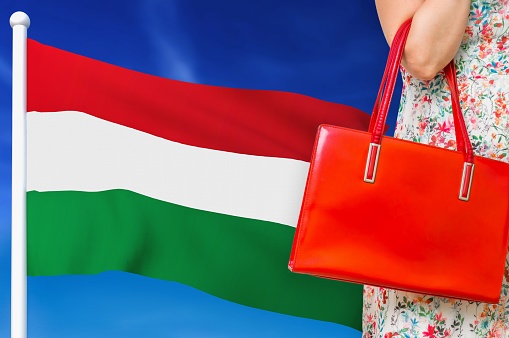 Shopping in Hungary. Woman with red leather bag is shopping in shopping center.