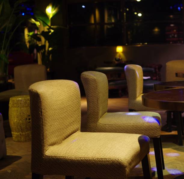 istock Vintage lounge chairs with purple spotlight 1202697033