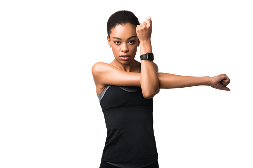Workout Concept. Motivated African American Woman Doing Deltoid Arm Stretch Exercising Over White Background. Studio Shot
