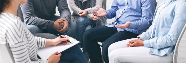 istock Trust circle. Group of unrecognizable people sitting together at therapy session 1202698548