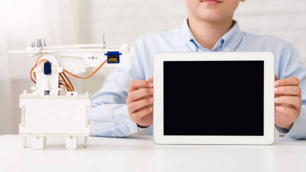 istock Mockup for advertisement. Boy holding tablet with blank screen 1202698578