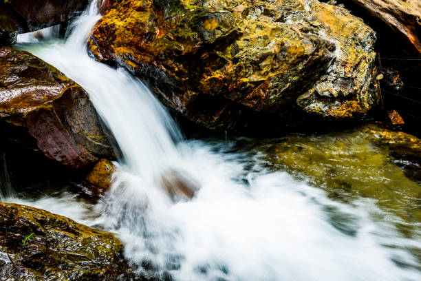 istock The stone under the waterfall, close-up as background. 1202698780