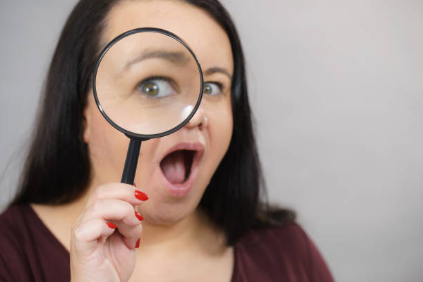 istock Adult woman with magnifying glss 1202700245