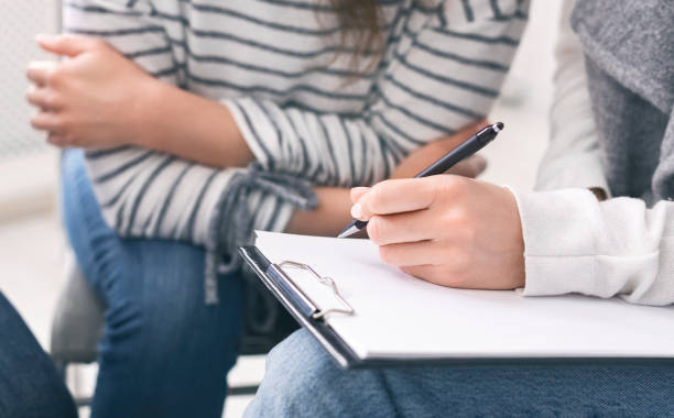 istock Specialist taking notes during psychotherapy session with young woman 1202700248