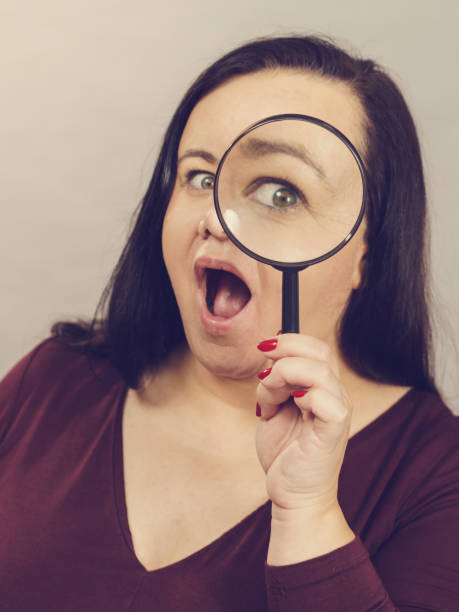 istock Adult woman with magnifying glss 1202700264