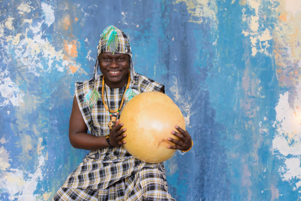 istock Handsome African man with traditional clothes and musical instruments 1202700375