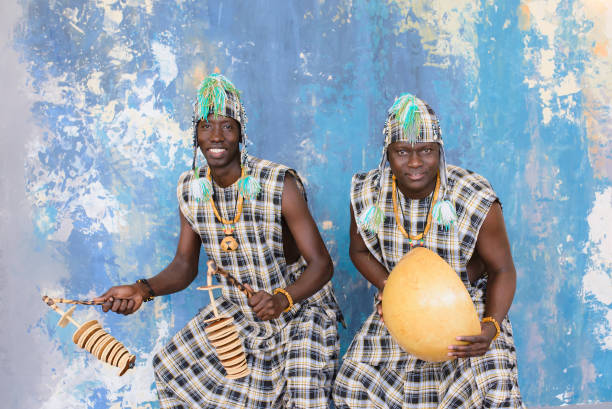 istock African artists with traditional musical instruments on blue wall background. 1202700378