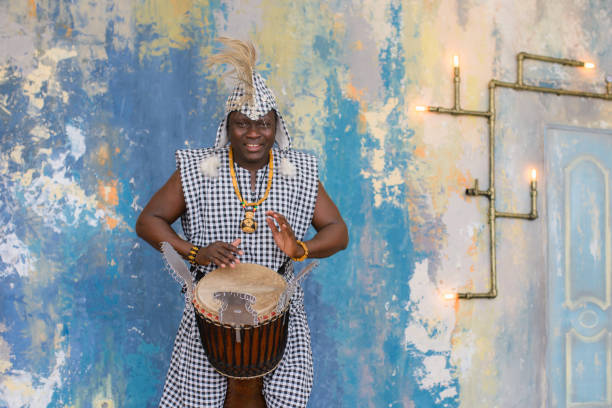 istock African artist in traditional clothes playing djembe drum 1202700552