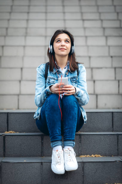 istock Using phone and listening to music 1202700717